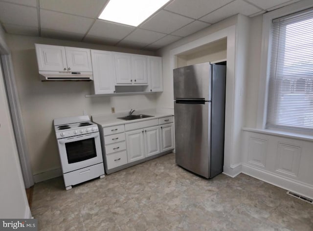 138 W 4th St, Bridgeport, PA 19405 - kitchen featuring freestanding refrigerator, white range with electric stovetop, a sink, under cabinet range hood, and white cabinets