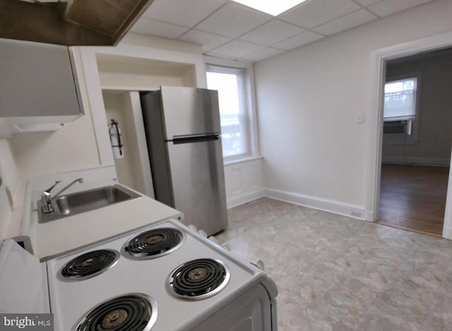 138 W 4th St, Bridgeport, PA 19405 - kitchen with freestanding refrigerator, a sink, white electric range oven, light floors, and baseboards