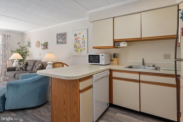 8 35th St Unit 401, Ocean City, MD 21842 - kitchen with white appliances, open floor plan, a peninsula, light countertops, and wood finished floors