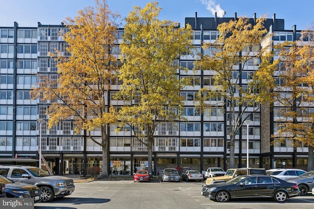view of apartment building / complex featuring uncovered parking