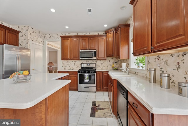 kitchen featuring appliances with stainless steel finishes, a sink, light countertops, light tile patterned floors, and recessed lighting