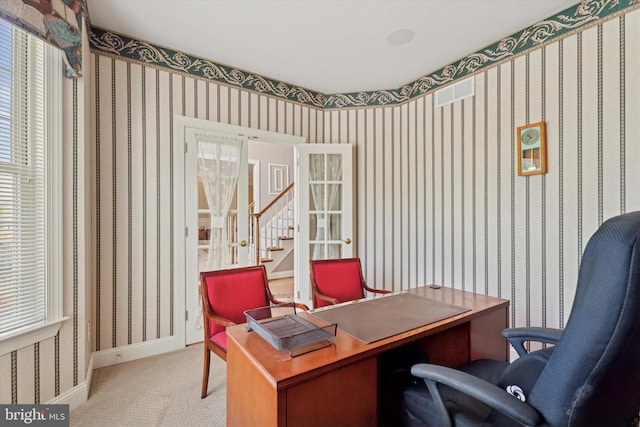 carpeted home office featuring baseboards