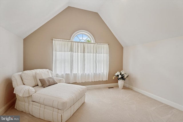 sitting room with carpet, vaulted ceiling, and baseboards