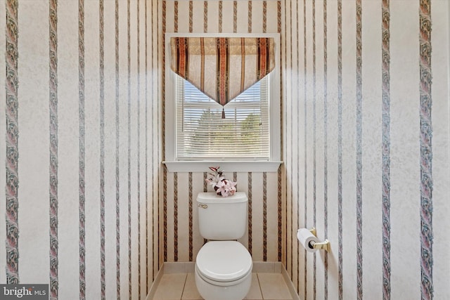 bathroom with wallpapered walls, tile patterned floors, and toilet