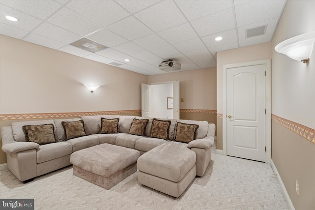 living area with a paneled ceiling, light colored carpet, recessed lighting, and baseboards