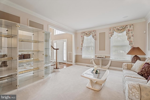 carpeted living room featuring ornamental molding and baseboards