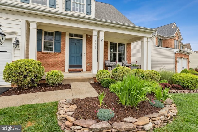 10611 Tattersall Dr, Manassas, VA 20112 - property entrance with a porch, brick siding, and roof with shingles
