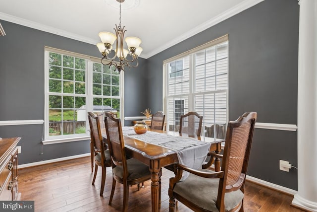 10611 Tattersall Dr, Manassas, VA 20112 - dining area with a chandelier, healthy amount of natural light, baseboards, crown molding, and hardwood / wood-style floors