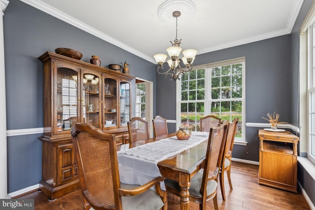 10611 Tattersall Dr, Manassas, VA 20112 - dining room with a chandelier, crown molding, baseboards, and hardwood / wood-style flooring