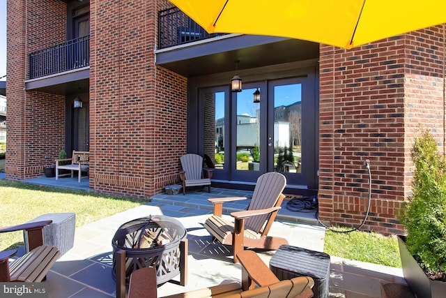 23109 Cottonwillow Sq, Brambleton, VA 20148 - view of patio with french doors, an outdoor fire pit, and a balcony