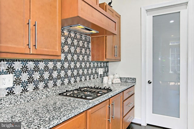 23109 Cottonwillow Sq, Brambleton, VA 20148 - kitchen with stainless steel gas cooktop, premium range hood, backsplash, and light stone counters