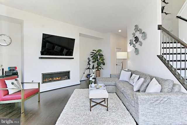 23109 Cottonwillow Sq, Brambleton, VA 20148 - living room with wood finished floors, recessed lighting, stairs, and a glass covered fireplace