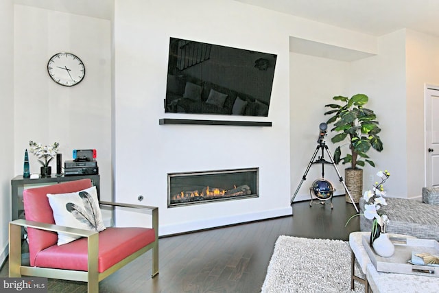 23109 Cottonwillow Sq, Brambleton, VA 20148 - living room with wood finished floors, baseboards, and a glass covered fireplace
