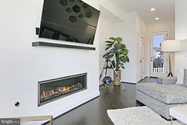 23109 Cottonwillow Sq, Brambleton, VA 20148 - living area with wood finished floors, recessed lighting, baseboards, and a glass covered fireplace