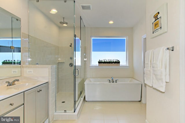 23109 Cottonwillow Sq, Brambleton, VA 20148 - full bathroom featuring a shower stall, a garden tub, vanity, tile patterned flooring, and recessed lighting