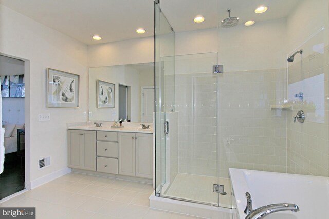 23109 Cottonwillow Sq, Brambleton, VA 20148 - full bath with a shower stall, a tub to relax in, double vanity, baseboards, and ensuite bath