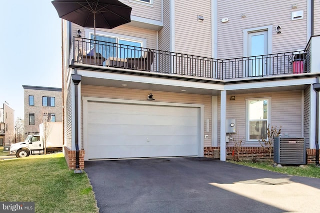 23109 Cottonwillow Sq, Brambleton, VA 20148 - view of front facade featuring an attached garage, central AC unit, a balcony, and asphalt driveway