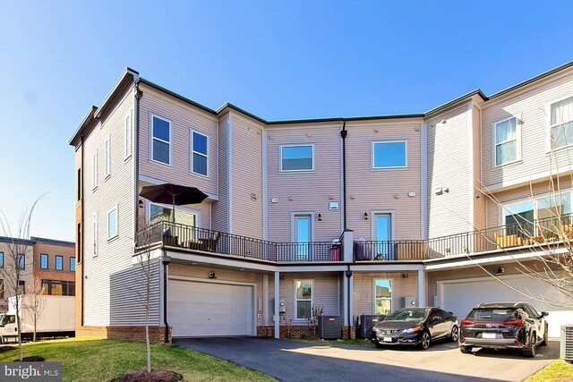 23109 Cottonwillow Sq, Brambleton, VA 20148 - back of house featuring driveway, a garage, and central AC
