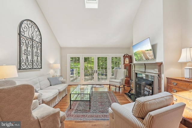 36 Wingstone Ln, Devon, PA 19333 - living area with high vaulted ceiling, wood finished floors, a fireplace with flush hearth, and french doors