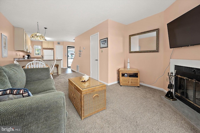 614 Osprey Rd Unit D, Ocean City, MD 21842 - living room featuring light colored carpet, a glass covered fireplace, and baseboards