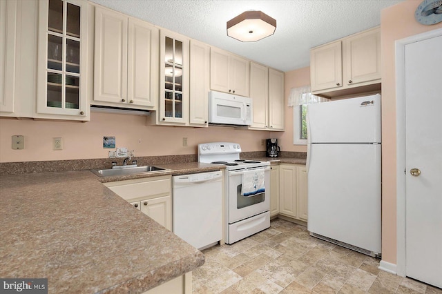 614 Osprey Rd Unit D, Ocean City, MD 21842 - kitchen featuring white appliances, a sink, cream cabinets, glass insert cabinets, and stone finish floors