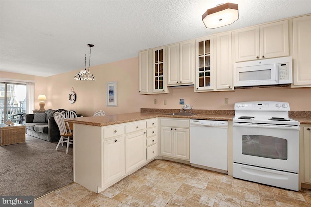 614 Osprey Rd Unit D, Ocean City, MD 21842 - kitchen with white appliances, open floor plan, a sink, a peninsula, and glass insert cabinets