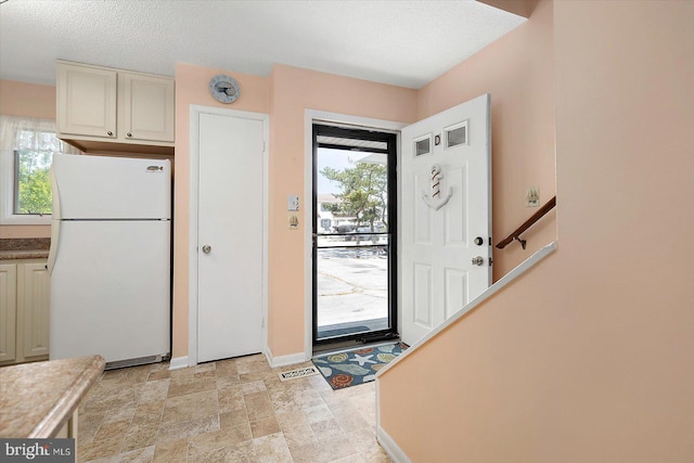 614 Osprey Rd Unit D, Ocean City, MD 21842 - entrance foyer featuring baseboards, light stone finish flooring, and a textured ceiling