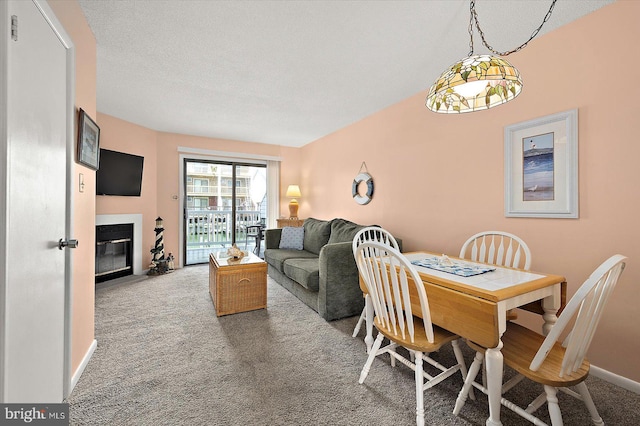 614 Osprey Rd Unit D, Ocean City, MD 21842 - dining room featuring carpet floors, a fireplace with flush hearth, and baseboards