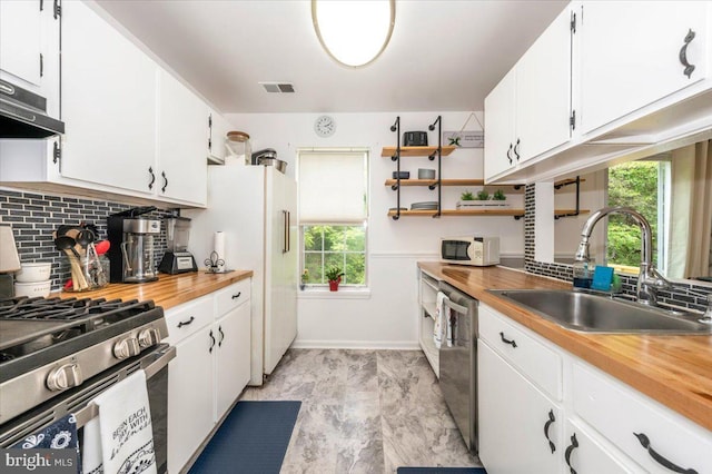 10625 Shasta Ct Unit T, Damascus, MD 20872 - kitchen featuring stainless steel appliances, a sink, decorative backsplash, and butcher block countertops
