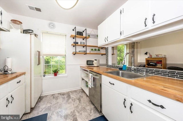 10625 Shasta Ct Unit T, Damascus, MD 20872 - kitchen with dishwasher, butcher block counters, a sink, freestanding refrigerator, and white cabinetry