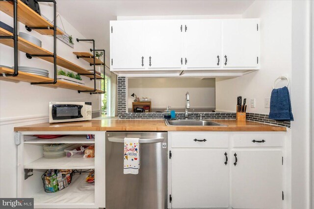 10625 Shasta Ct Unit T, Damascus, MD 20872 - kitchen with stainless steel dishwasher, open shelves, a sink, white microwave, and white cabinets
