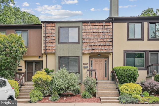 10707 Muirfield Dr, Potomac, MD 20854 - townhome / multi-family property with mansard roof and stucco siding