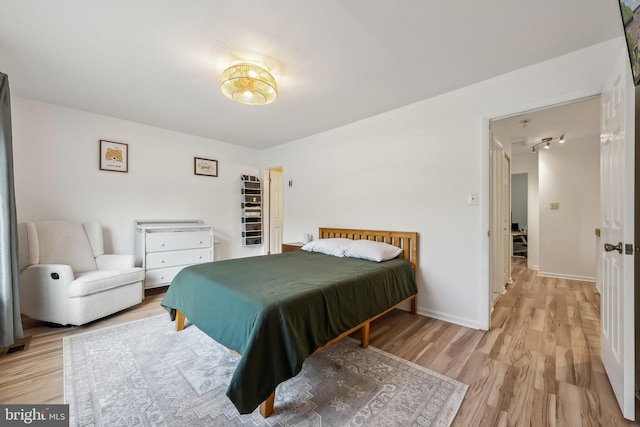 10707 Muirfield Dr, Potomac, MD 20854 - bedroom with light wood-style flooring, baseboards, and track lighting