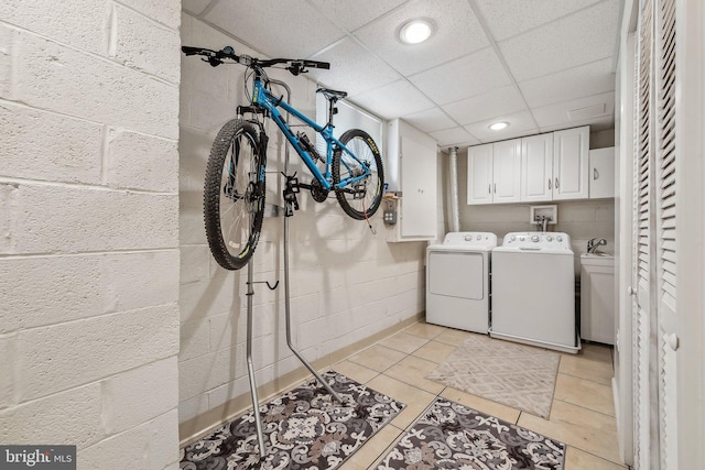 10707 Muirfield Dr, Potomac, MD 20854 - washroom with washing machine and dryer, cabinet space, concrete block wall, light tile patterned flooring, and recessed lighting