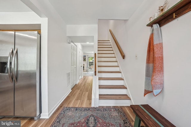 10707 Muirfield Dr, Potomac, MD 20854 - stairs with wood finished floors and baseboards