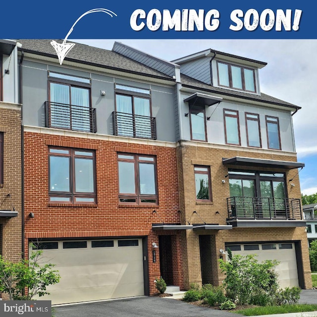 view of front of property featuring an attached garage, brick siding, driveway, and a balcony