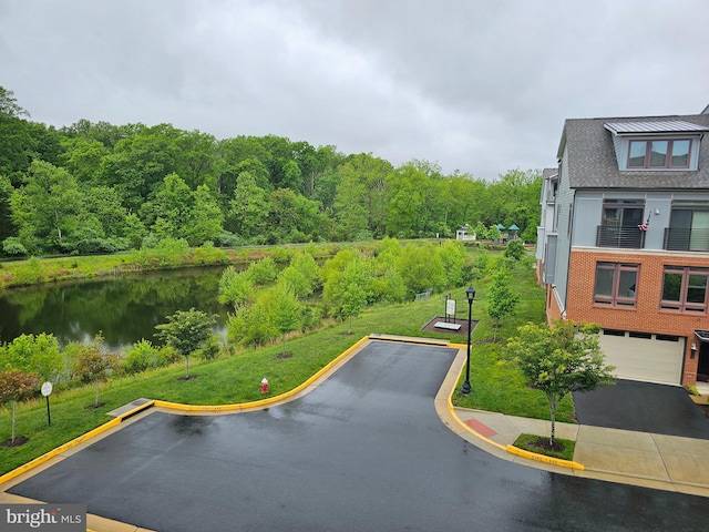 bird's eye view of a nearby body of water and a heavily wooded area