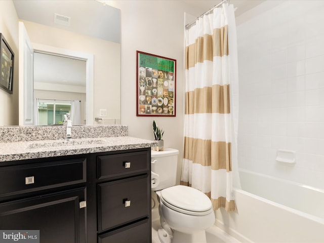 bathroom with toilet, vanity, and shower / bath combo