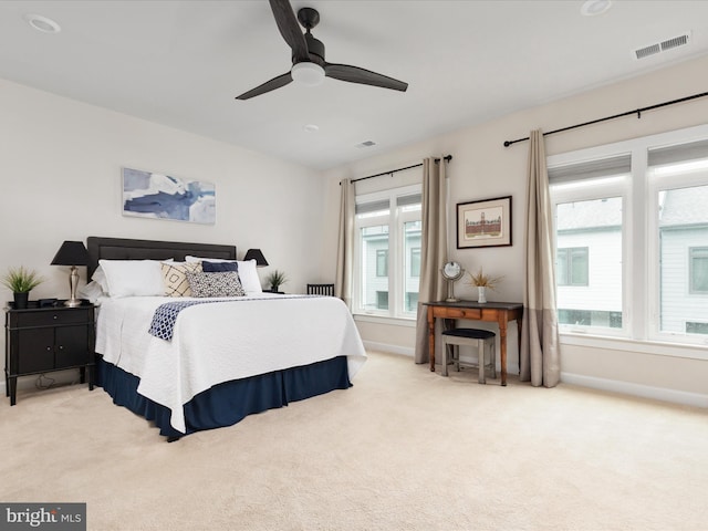 bedroom with light carpet, baseboards, and ceiling fan