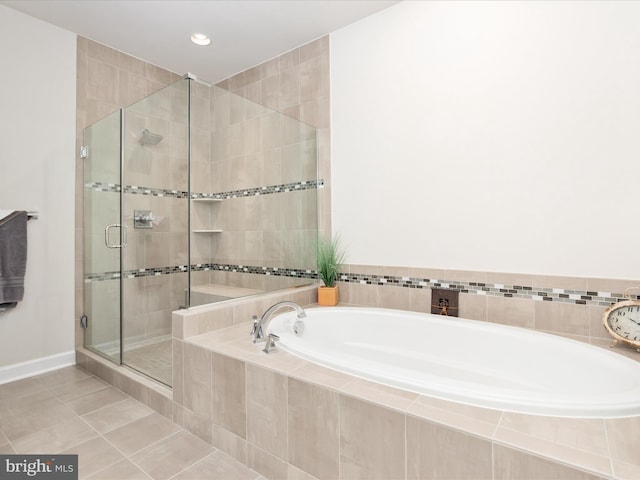 bathroom featuring a stall shower, tile patterned floors, a garden tub, recessed lighting, and baseboards