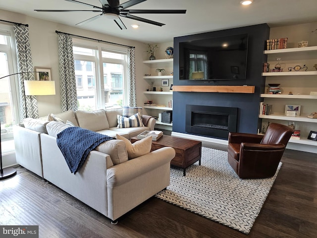 living room with a fireplace, wood finished floors, recessed lighting, and a ceiling fan