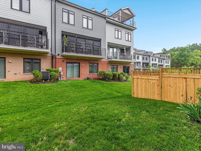 back of property featuring brick siding and central air condition unit