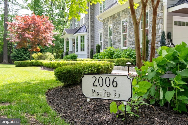 community sign with a lawn and a garage
