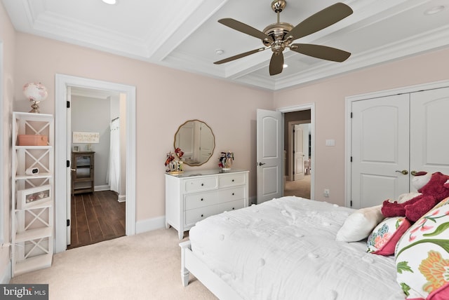 bedroom with carpet flooring, crown molding, a closet, a ceiling fan, and baseboards