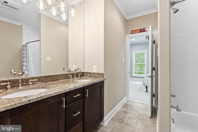 full bathroom featuring baseboards, crown molding, double vanity, stone finish flooring, and shower / bath combo