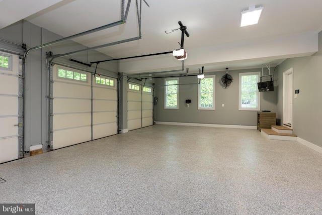 garage featuring a garage door opener and baseboards