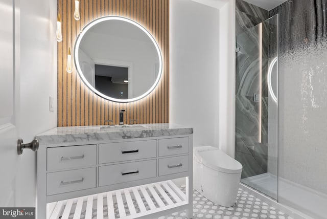 full bath with a stall shower, vanity, and toilet