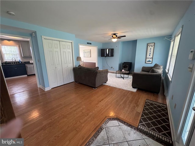 18 Cub Ln, Jim Thorpe, PA 18229 - living area featuring a wood stove, ceiling fan, light tile patterned floors, and baseboards
