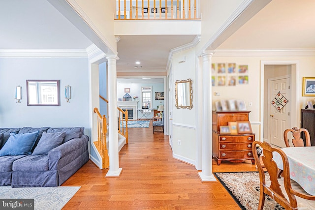 9 Webster Hill Ct, Clarksburg, MD 20871 - entrance foyer with ornate columns, crown molding, light wood-style flooring, stairs, and healthy amount of natural light