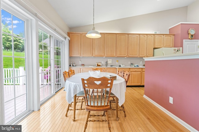 103 Dylan Cir, Avondale, PA 19311 - kitchen with light brown cabinetry, light countertops, freestanding refrigerator, hanging light fixtures, and high vaulted ceiling